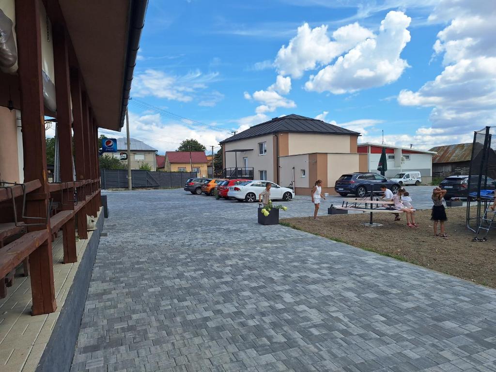 a group of children playing in a parking lot at BUBO Penzion & Restaurant in Moravany