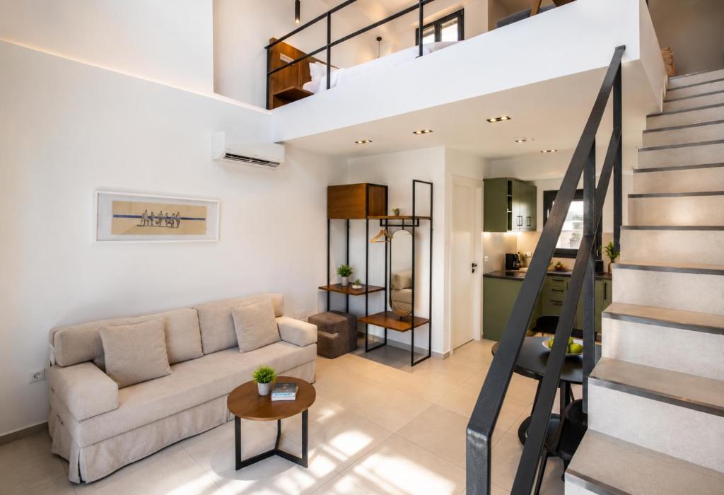 a living room with a couch and a staircase at Athens Genesis Luxury Suites By SEM in Athens