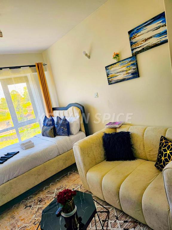a living room with a couch and a window at Bohen BnB 2 in Ongata Rongai 