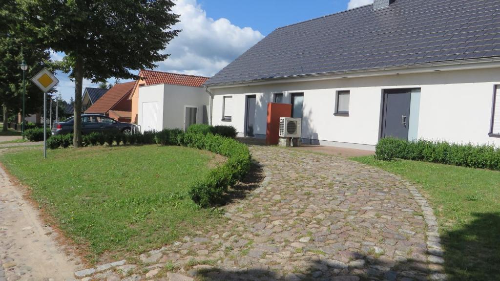 a house with a gravel driveway in front of it at Ferienhaus Lutowsee in Grammertin