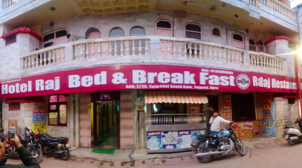 a building with motorcycles parked in front of it at Hotel Raj Bed And Breakfast in Agra