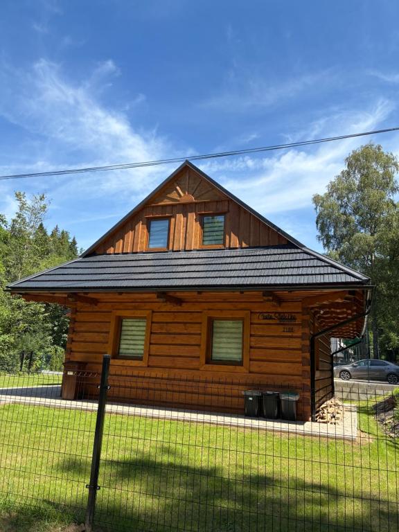 a wooden cabin with a gambrel roof at Chata v Oščadnici - Slniečko in Čadca