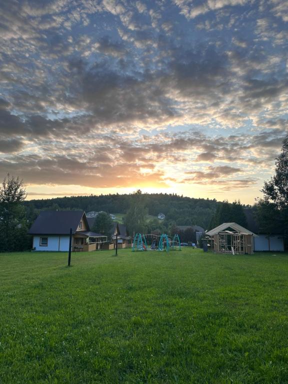 a field with a park with a playground at Podgórskie Zacisze in Bodzentyn