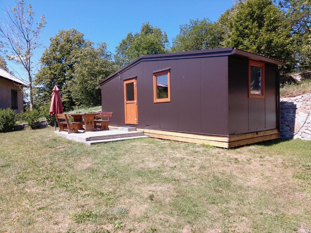 a purple tiny house sitting in a yard at Tiny house TIA in Nova Gorica