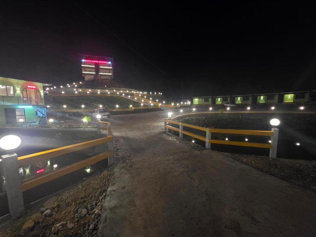 a night view of a bridge with lights at night at Hame Lana Resort in Mawlynnong