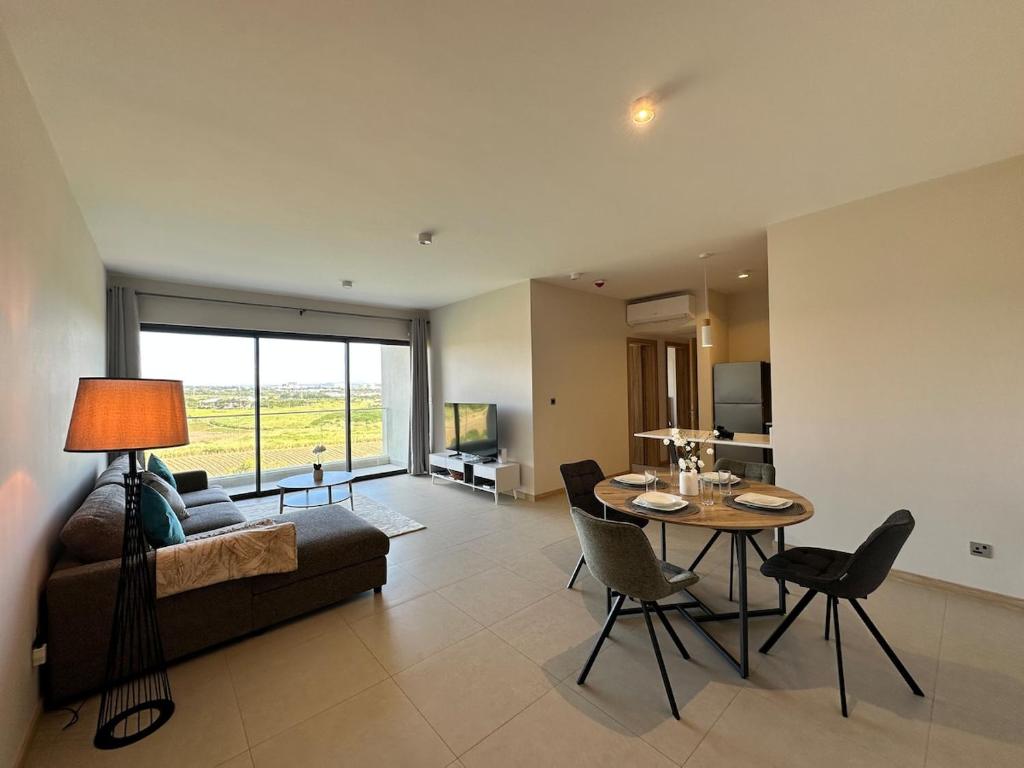 a living room with a couch and a table at Verdant Horizon in Moka