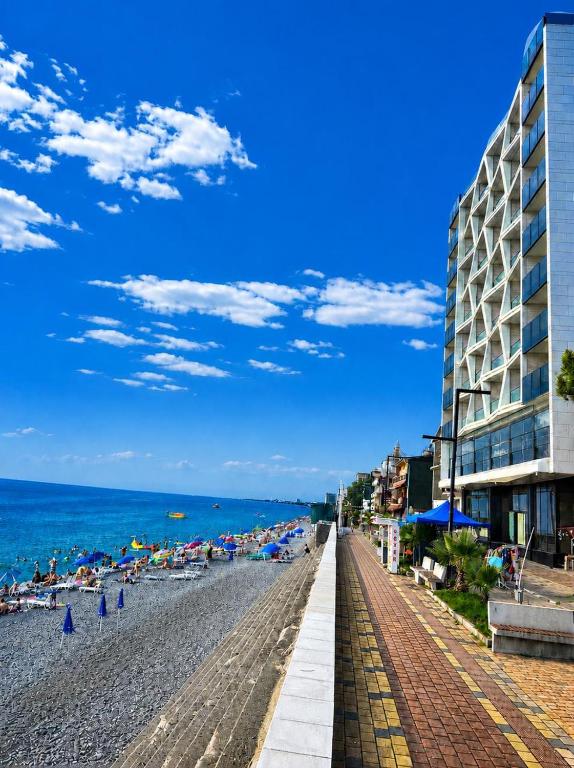 a view of a beach with buildings and the ocean at The New Jai Son in Kobuleti