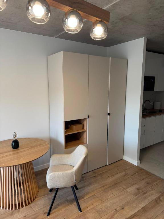 a dining room with a table and a chair at Róża- Lotnisko in Wrocław