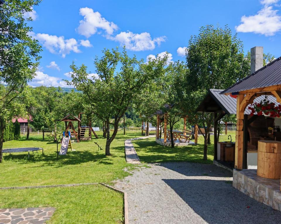 a park with a playground and a wooden pavilion at Maramures Landscape in Moisei