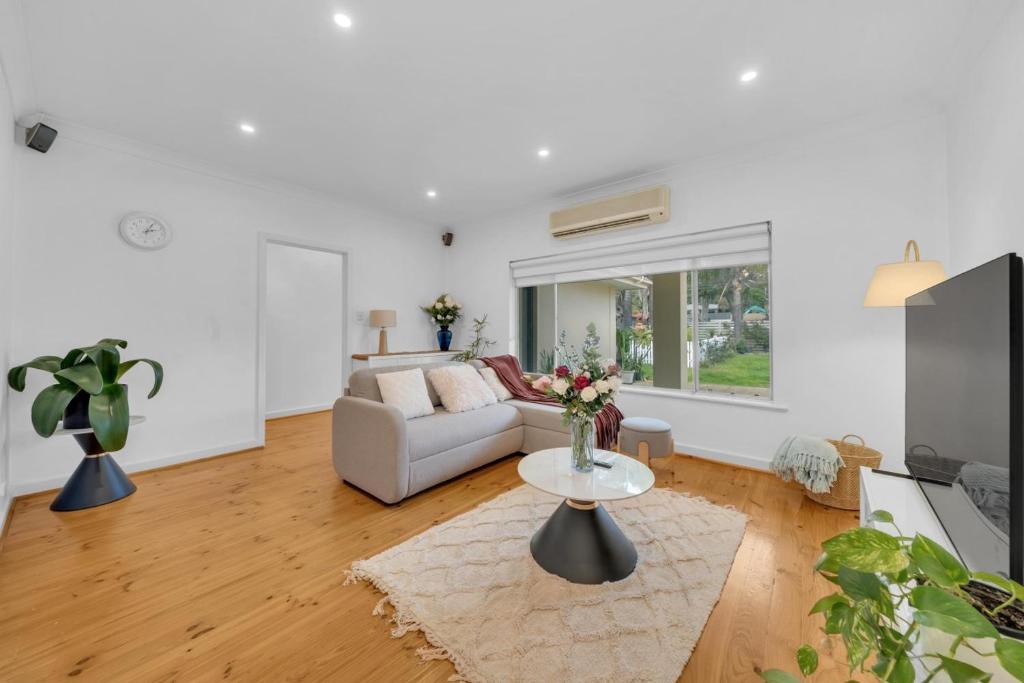 a living room with a couch and a table at 11 Guests 6BR, Granny Flat, 3 Kitchens, Hiking in Dernancourt