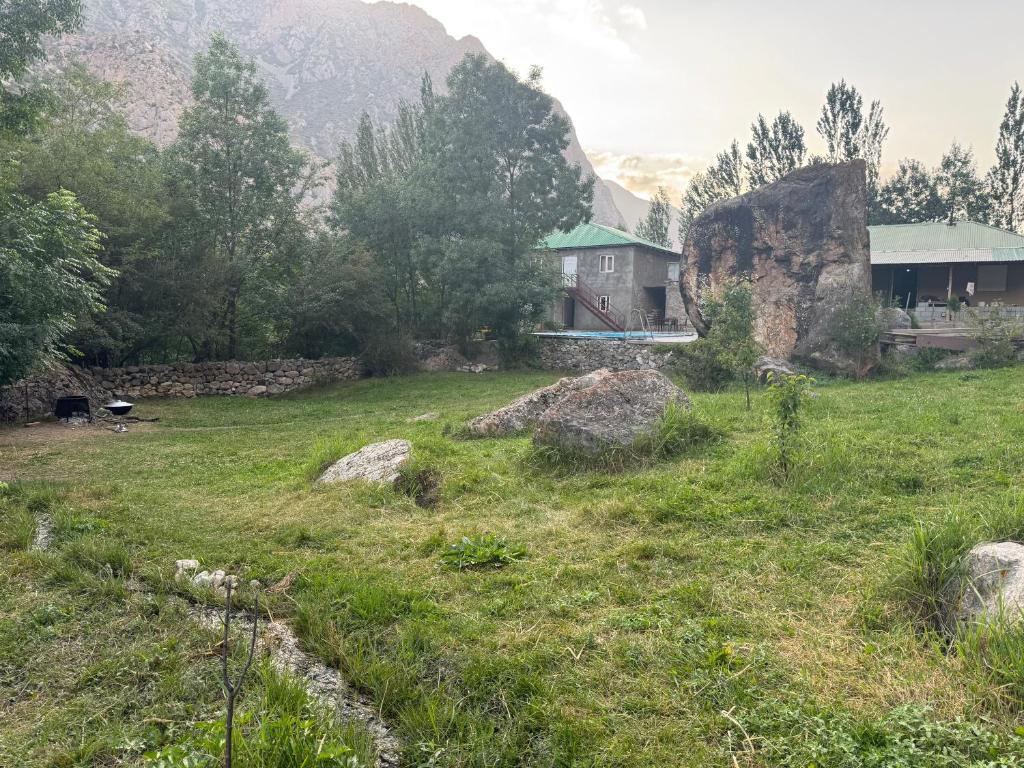 a house in the middle of a field at Sharsharai Haftkul in Panjakent