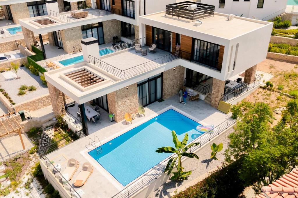 an aerial view of a house with a swimming pool at Kensington Villa - Private Pool & Rooftop Terrace by Azur Prime in Ayios Yeoryios