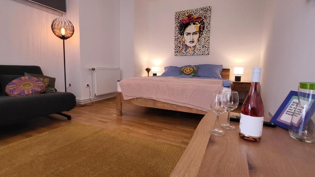 a bedroom with a bed and a table with wine glasses at Schubert's in Bruckneudorf