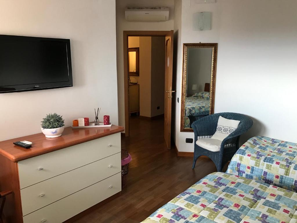 a living room with a dresser and a tv on the wall at Dimora Spina in Ferrazzano