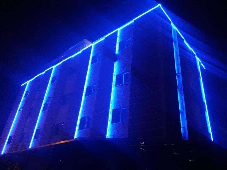 a building with blue lights on it at night at Barış hotel in Alasehir