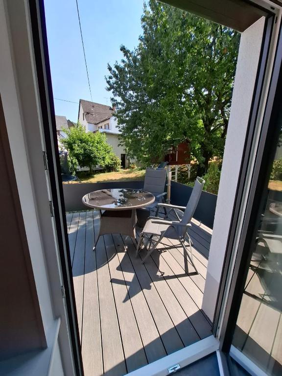 a balcony with a table and chairs on a deck at FeWo MaiFlo in Briedern