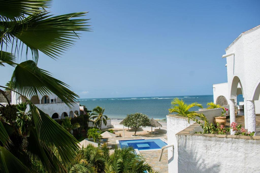 a view of the ocean from a resort with a swimming pool at Charming Penthouse -Holidays Houses in Malindi