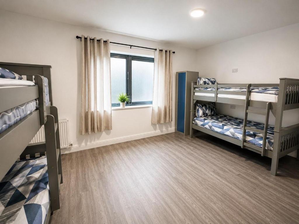a bedroom with two bunk beds and a window at The Central Dublin Hostel in Dublin