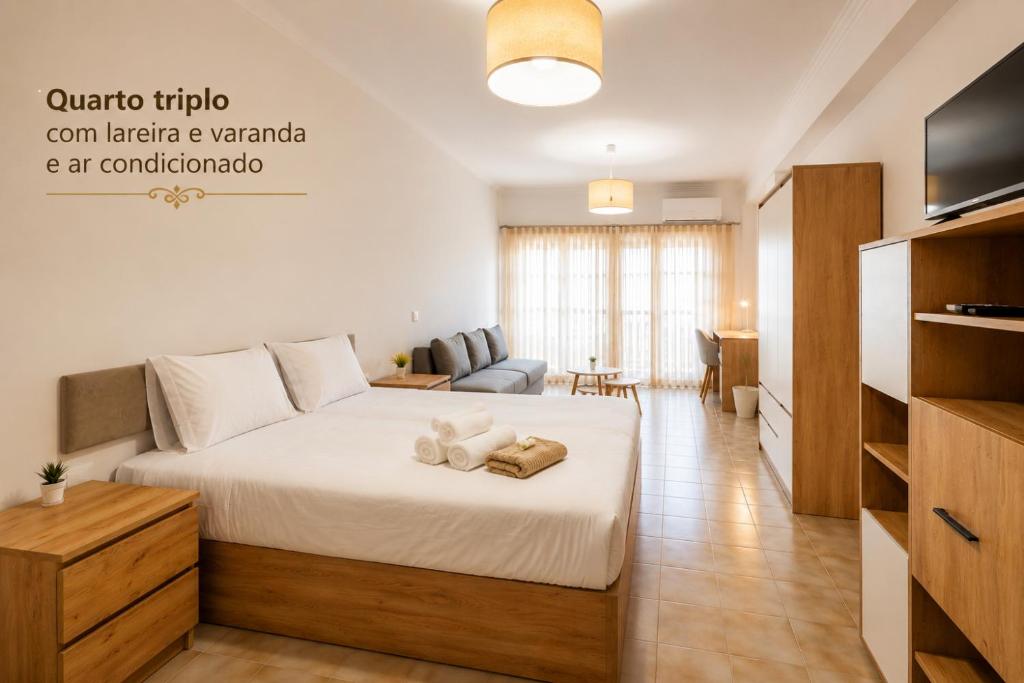 a bedroom with a bed and a living room at Rooms4you 1 in historic center of Braga in Braga