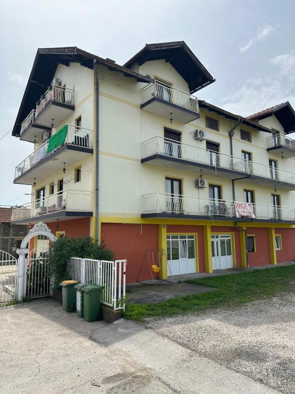 a large building with balconies on the side of it at Avdic Guest House in Makljenovac