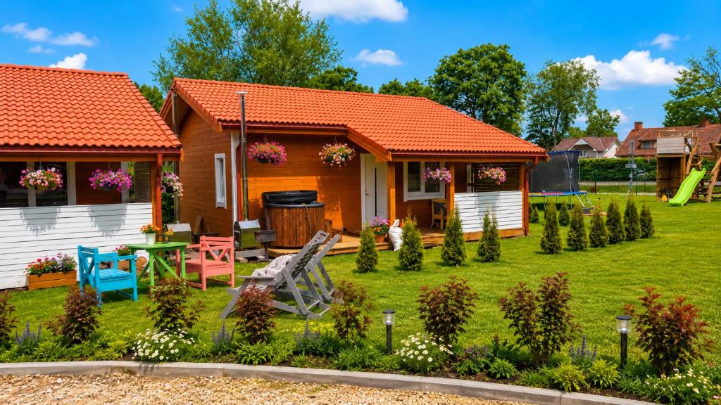 a small house with an orange roof at Edelweiss Vila Šventoji in Šventoji