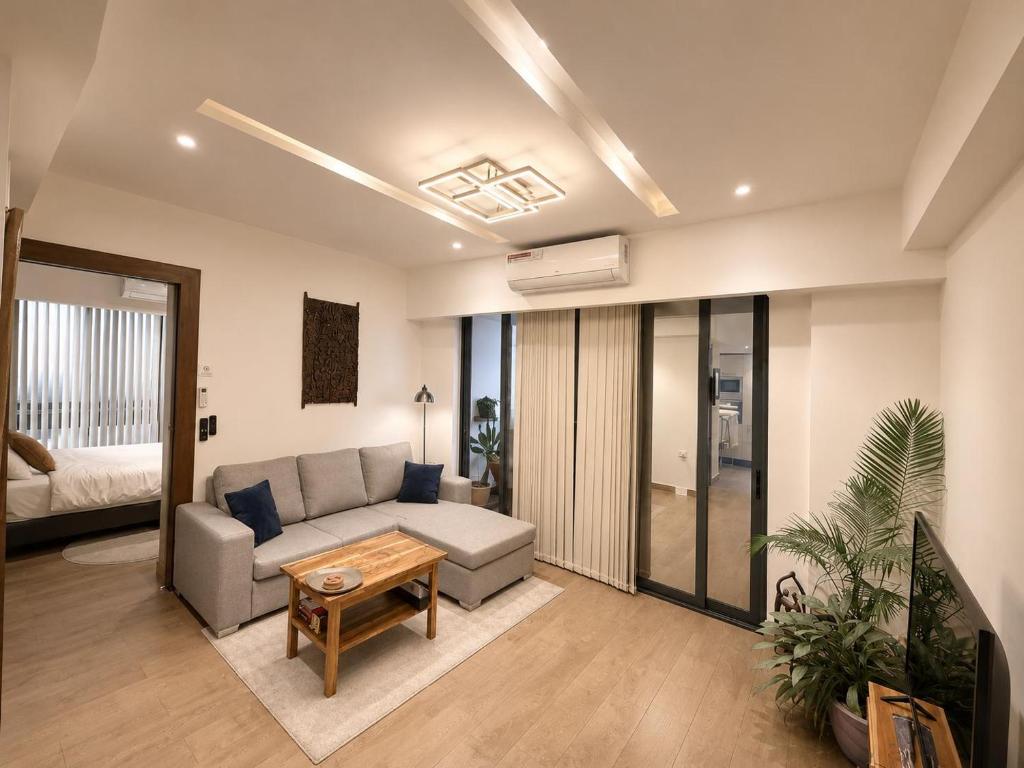 a living room with a couch and a table at SOLARIS APARTMENT-Sky Suites in Accra