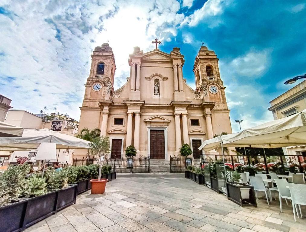 an old church with two towers with clocks on it at Sea Salt in Terrasini
