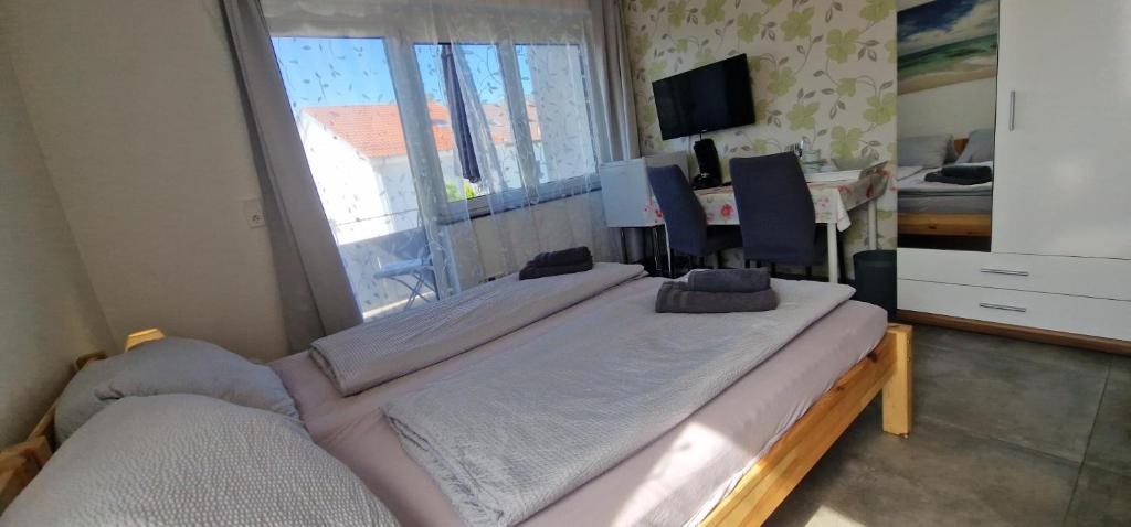 a large bed in a room with a window at Ferienunterkunft Bella Italia in Friedrichshafen