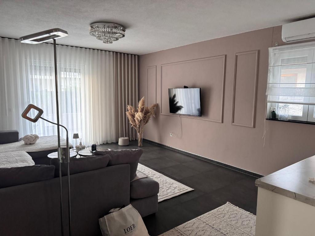 a living room with a couch and a table at Exclusive Una 4 in Bihać