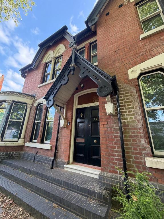 a house with a large gun on the front door at 7 Bed, 7 BR Victorian Accom - Sleeps 14 in Walsall