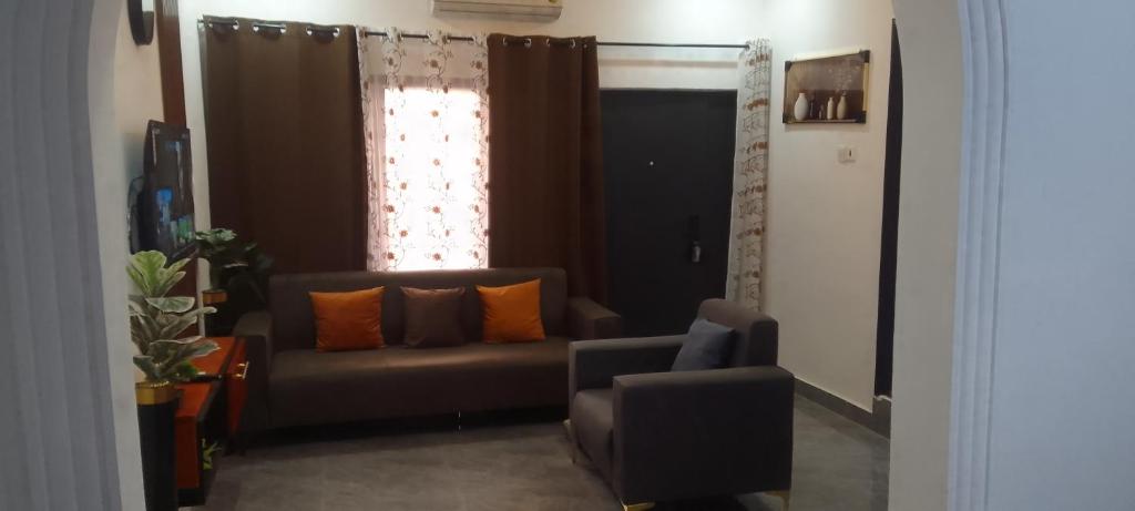 a living room with a couch and a window at MVH Apartment - Chamber and hall unit in Sunyani