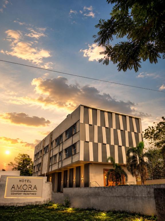 a hotel amara building in front of a sunset at HOTEL AMORA - Rajnandgaon in Rāj Nāndgaon