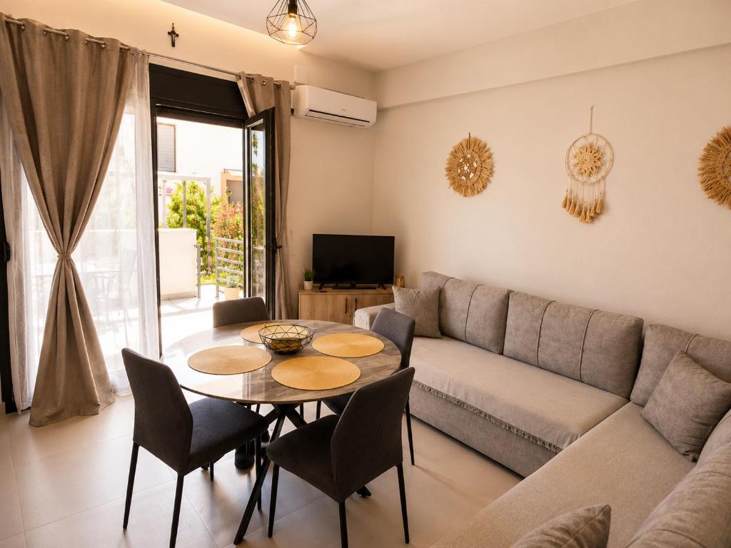 a living room with a couch and a table at Crystal 1 Apartment Ofrinio in Ofrínion