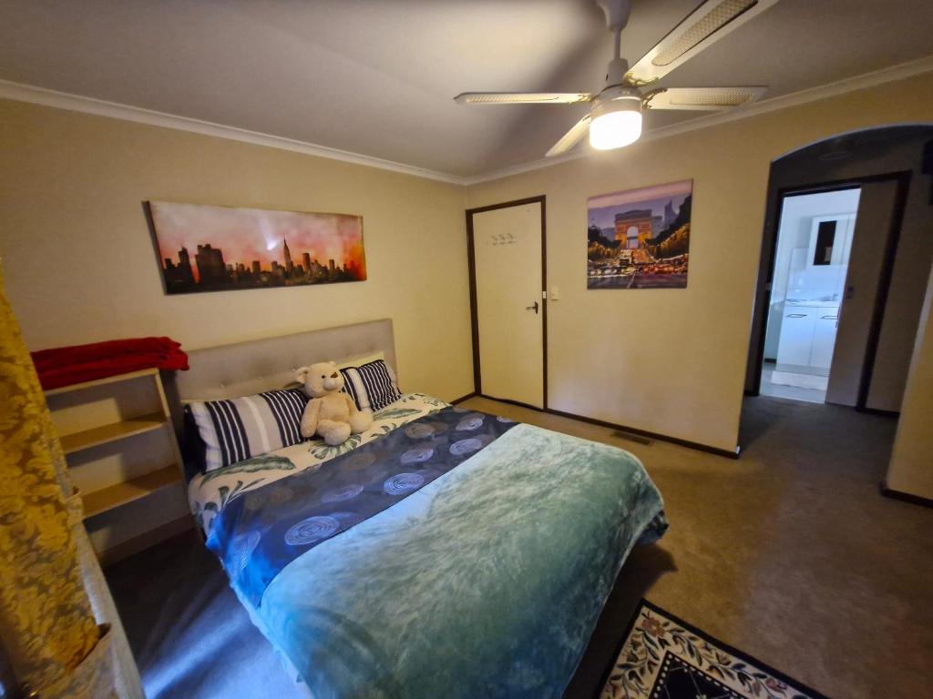 a bedroom with a bed with a teddy bear on it at Private Studio Ensuite & Kitchenette in Glen Waverley