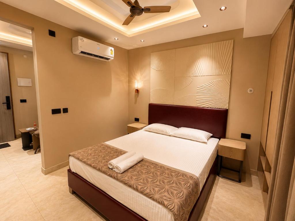 a bedroom with a bed and a ceiling fan at Livora Elite in Ghaziabad