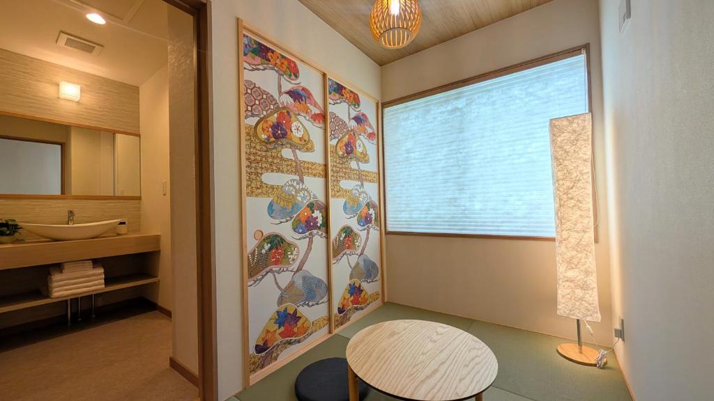 a bathroom with a large window and a table at Dream Stays HIKARI in Osaka