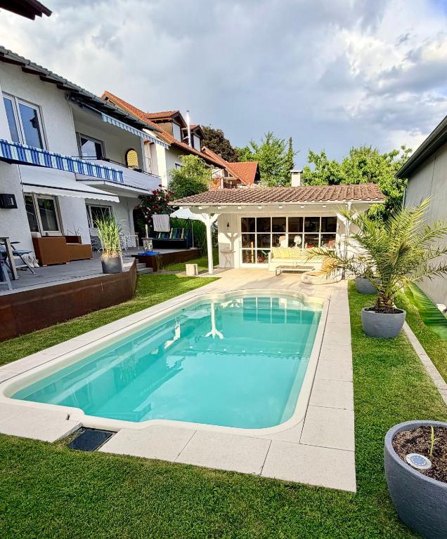 a swimming pool in the yard of a house at Apartment Prinz Luis in Owingen