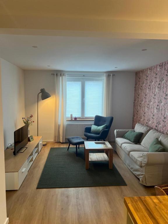 a living room with a couch and a chair at Landliebe Wemb in Weeze