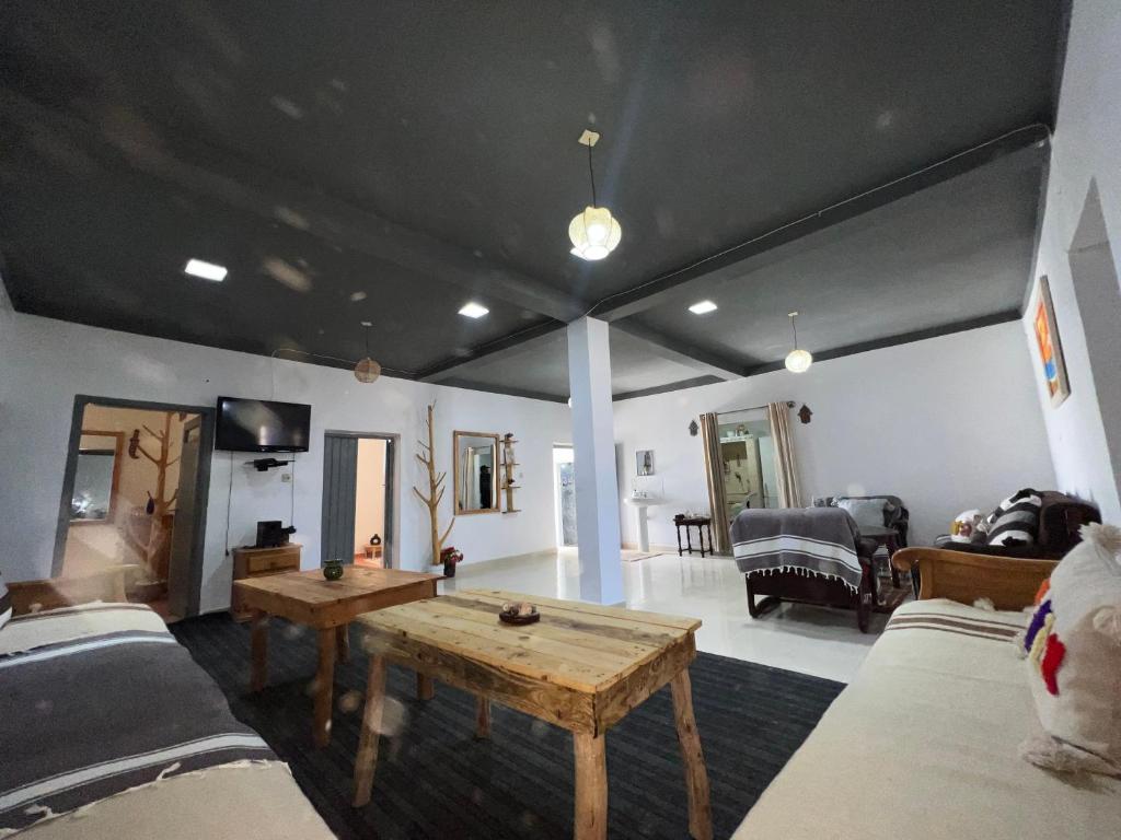 a living room with a table and a couch at Maison chez Hassan in Wassane