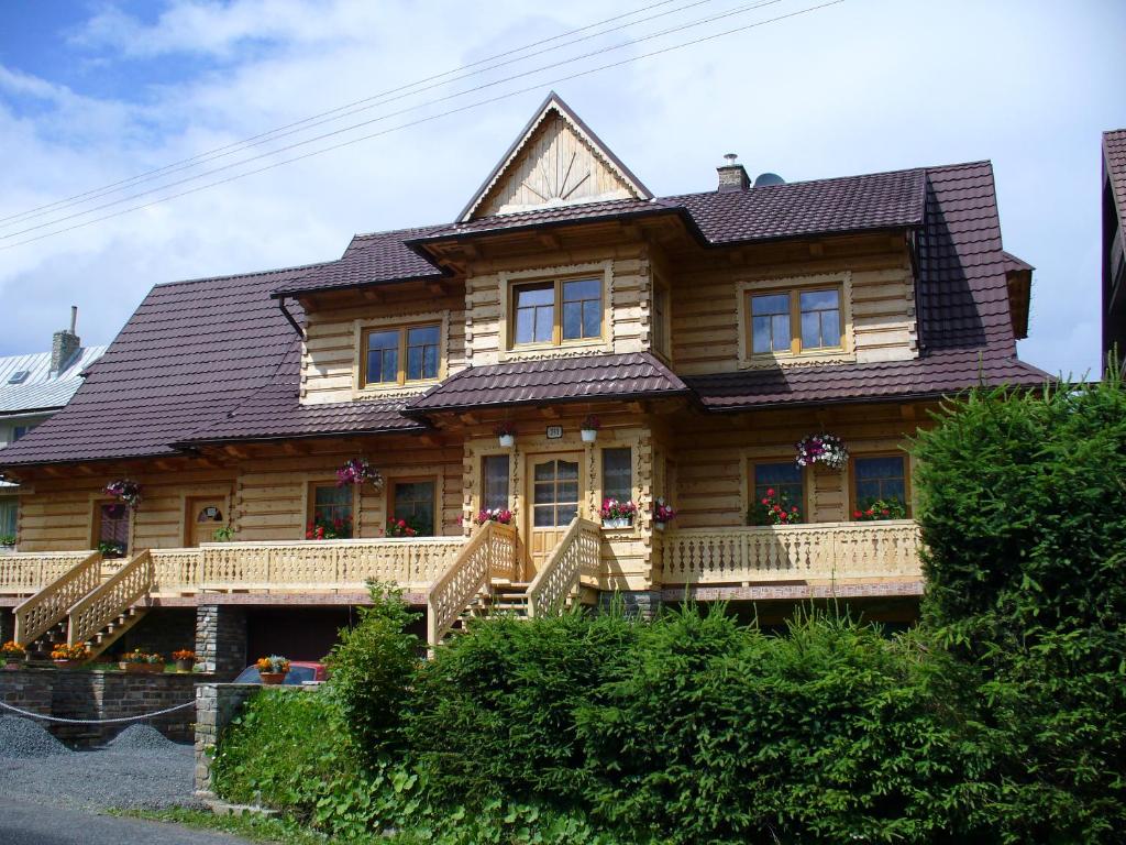 a wooden house with a gambrel roof at Drevenica Gabriel in Ždiar