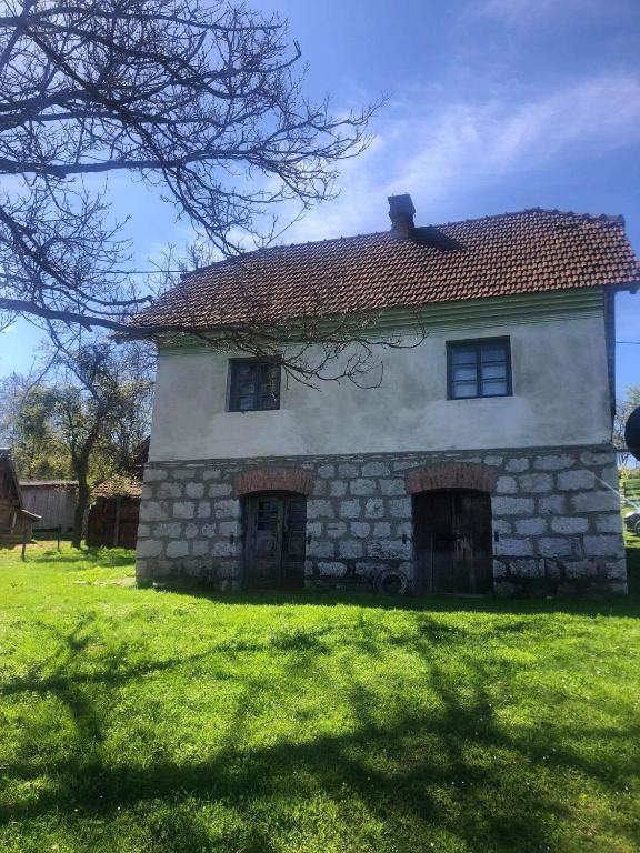 an old stone house on a green lawn at Vila Jelka in Kremna