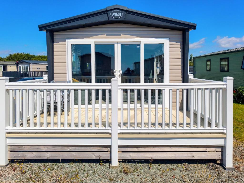 a screened in porch with a white fence at Peachy in Heysham