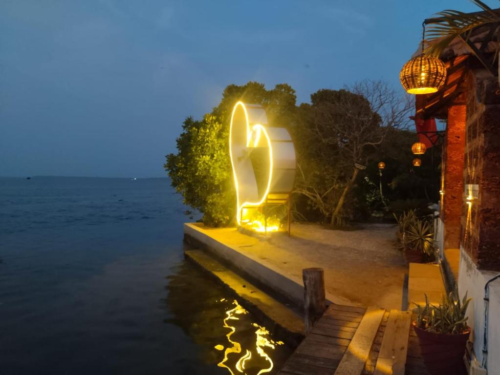 a light sculpture on the water at night at cascade island in Kollam