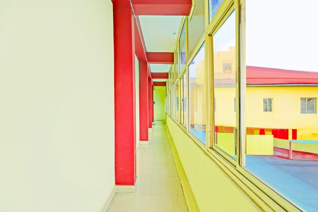 an empty hallway of a building with windows at Hotel O by OYO LA VGA RESIDENCY in Kottakupam