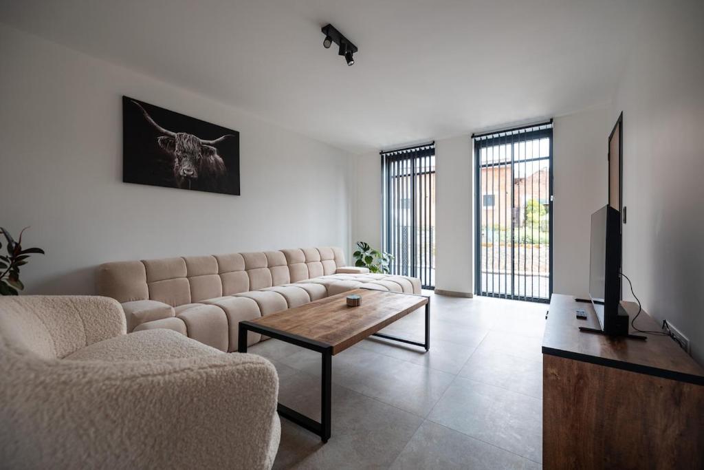 a living room with a couch and a coffee table at Klein Lauw 39 in Tongeren