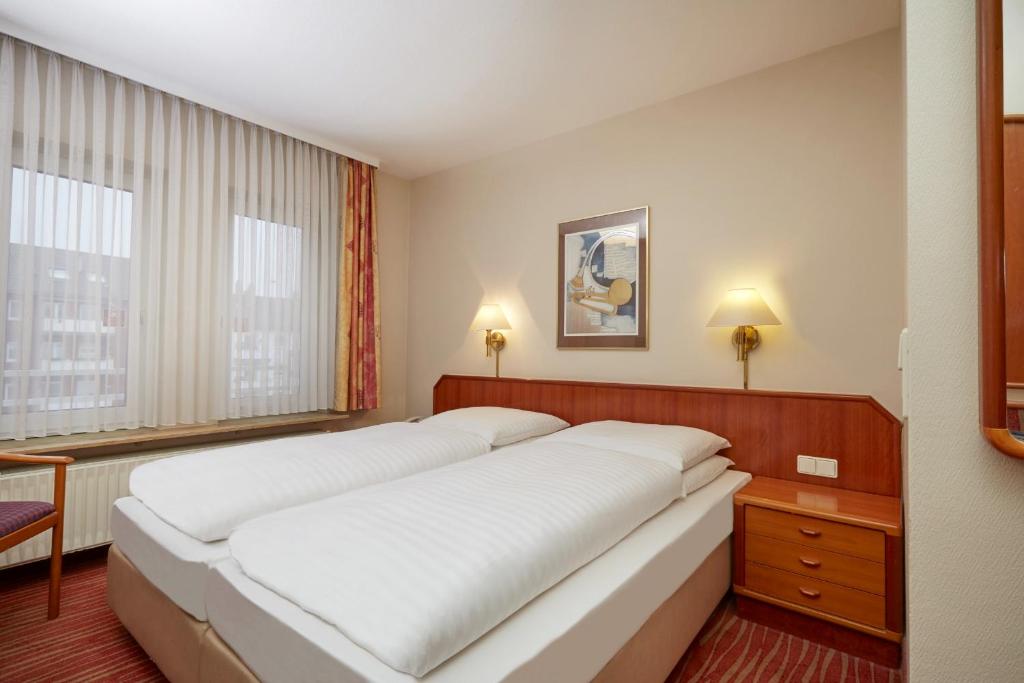 Ein Bett oder Betten in einem Zimmer der Unterkunft Novum Hotel Mannheim City