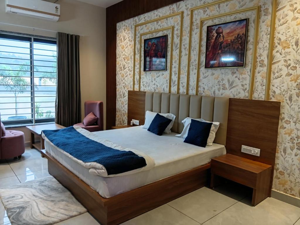 a bedroom with a large bed in a room at THE GK Resort in Ābu Road