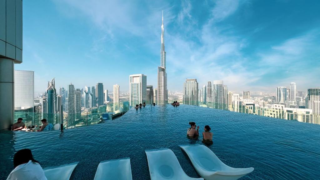 a infinity pool with a view of a city at Downtown Dubai's Highest Infinity Pool, Paramount Hotel Midtown in Dubai