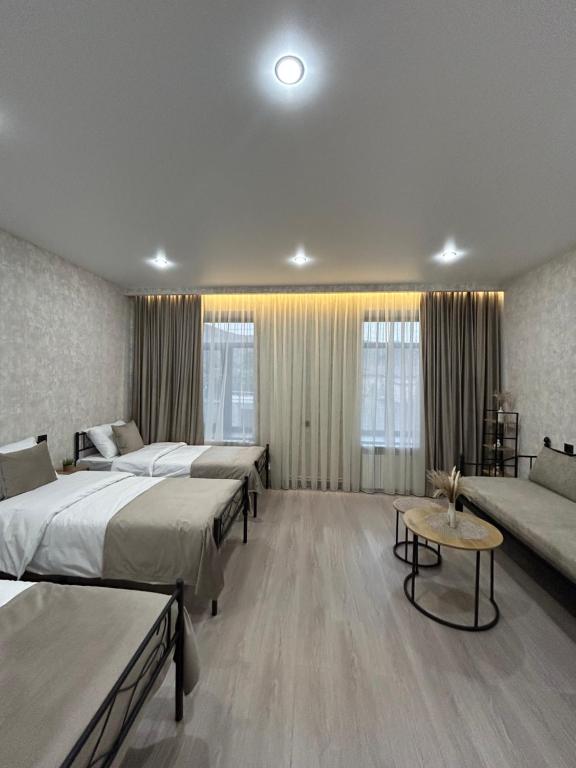 a hotel room with two beds and a couch at Linet Apartament in Goris