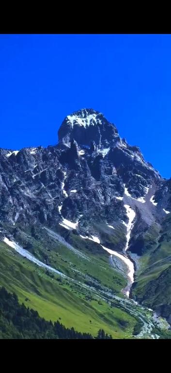 a mountain with snow on top of it at Ushba Hearth House in Tvebishi